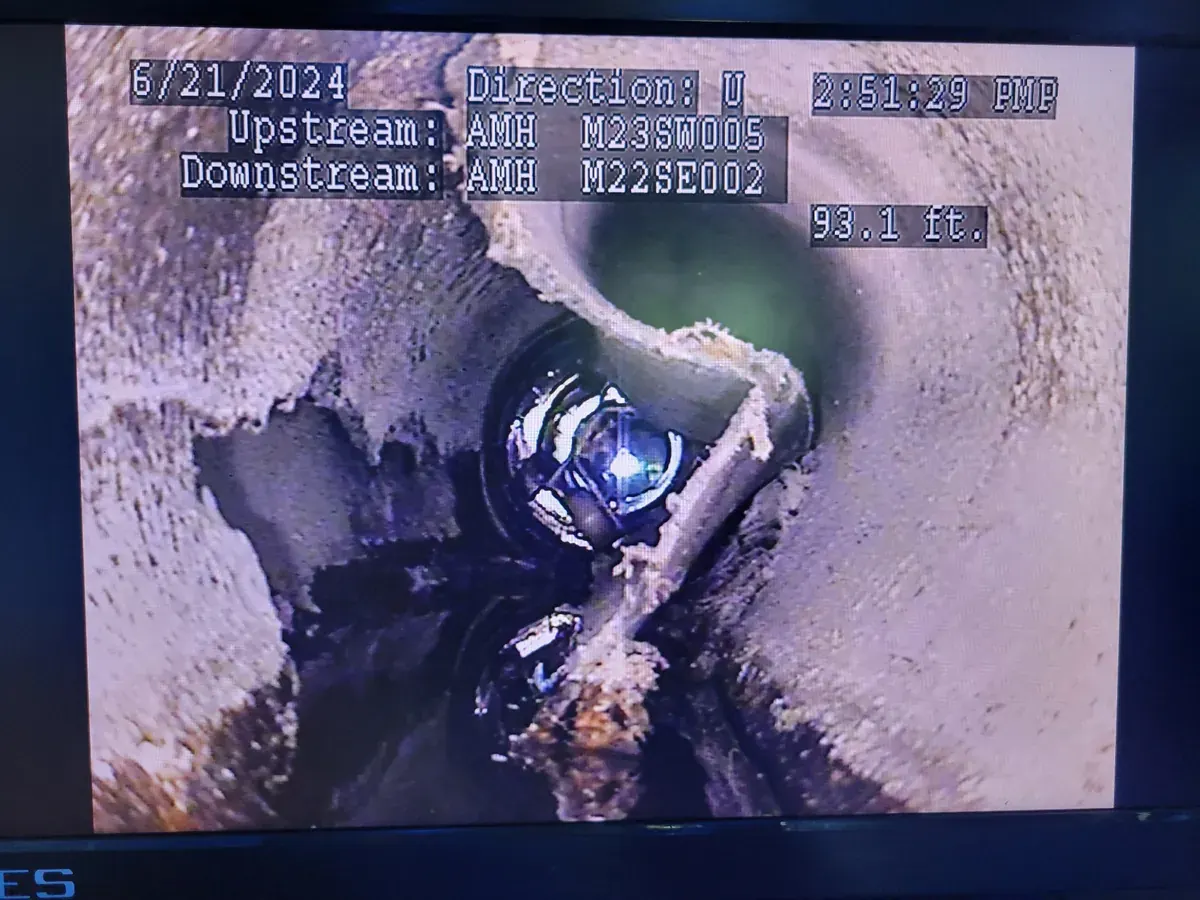 An inspection frame showing a service connection entering the main, with the survey reference data recorded across the top.