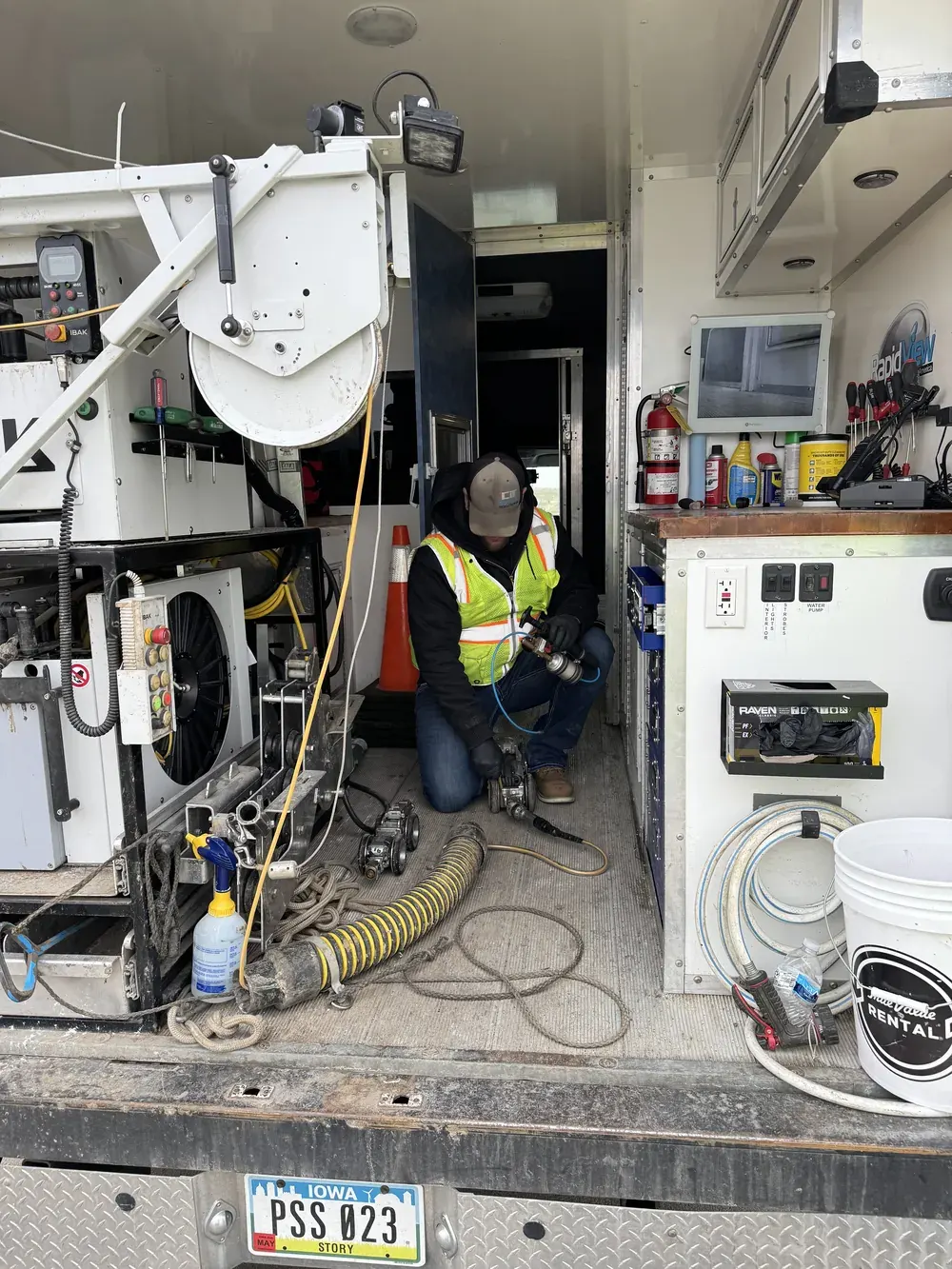 The interior of a CIT televising truck, showing the camera reel and cable equipment used for mainline inspection.