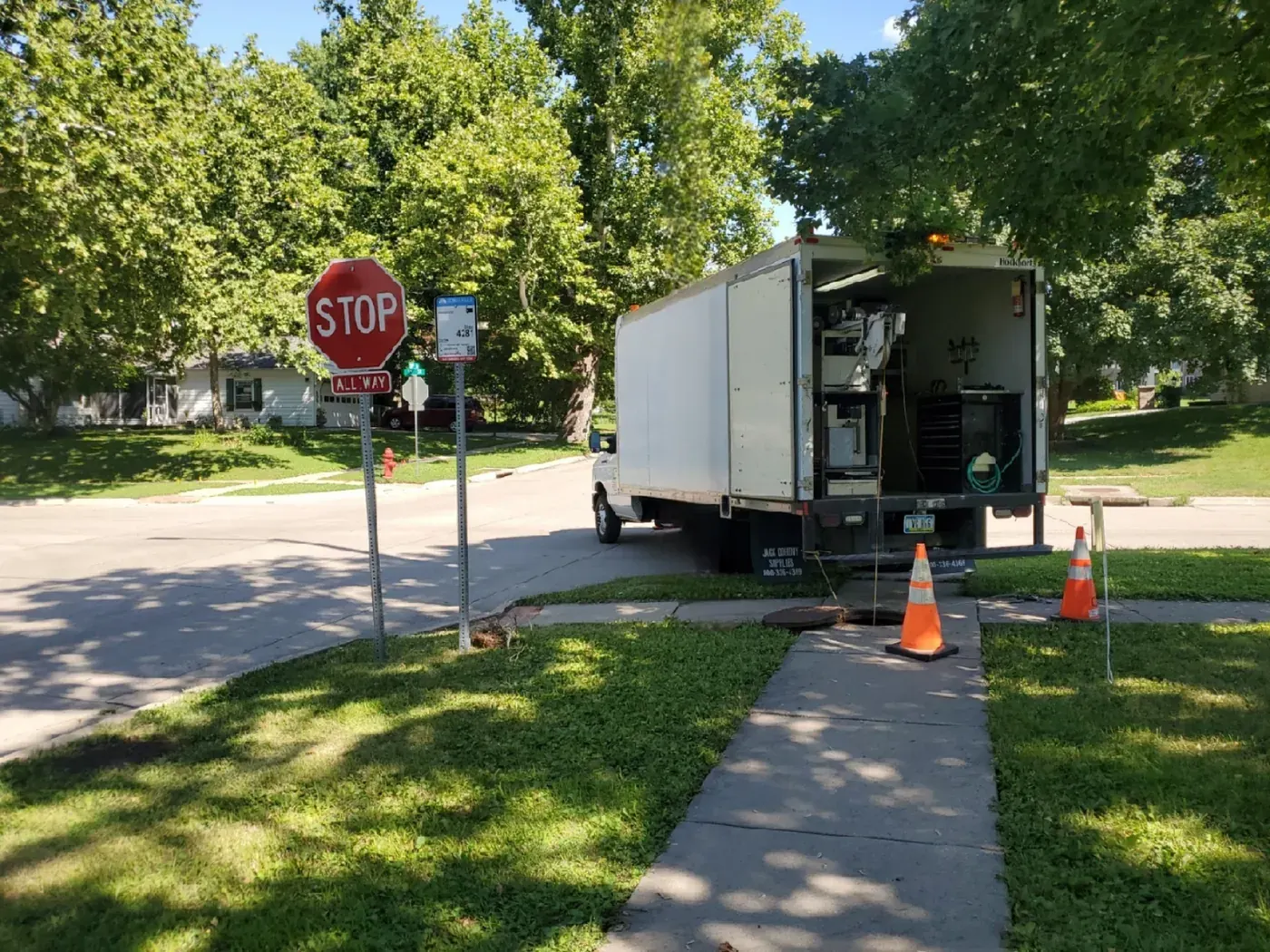 A CIT inspection van parked on a residential street during neighborhood collection system work.