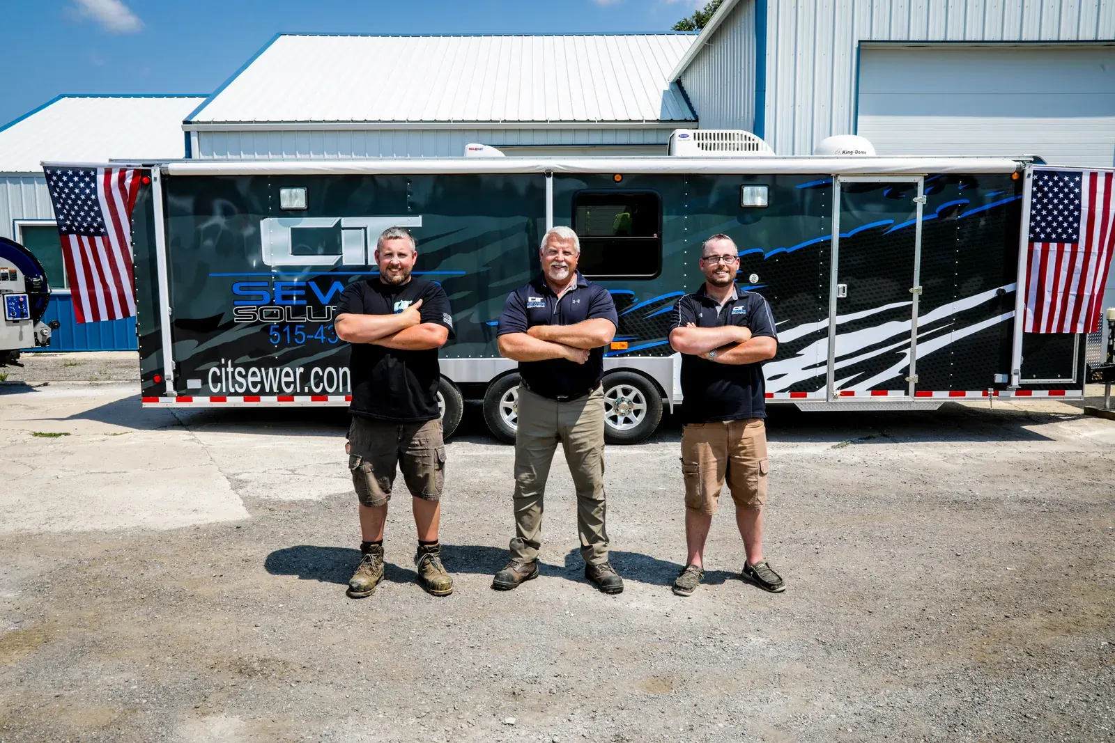 Members of the CIT Sewer Solutions team standing in front of a company trailer.