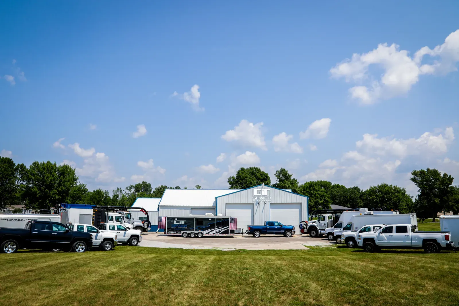 A ground-level view of the CIT Sewer Solutions yard and service fleet.