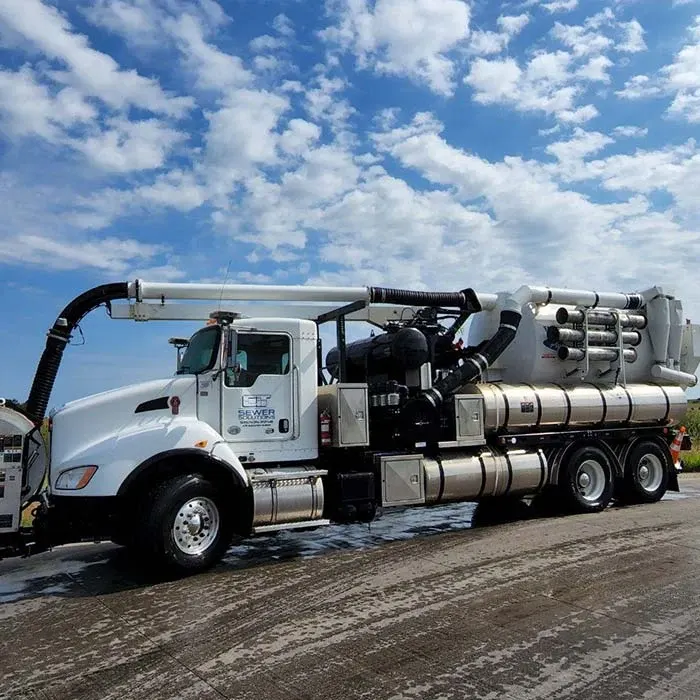 A side view of a CIT truck with its overhead vacuum boom, recovery tank and stored hose sections.