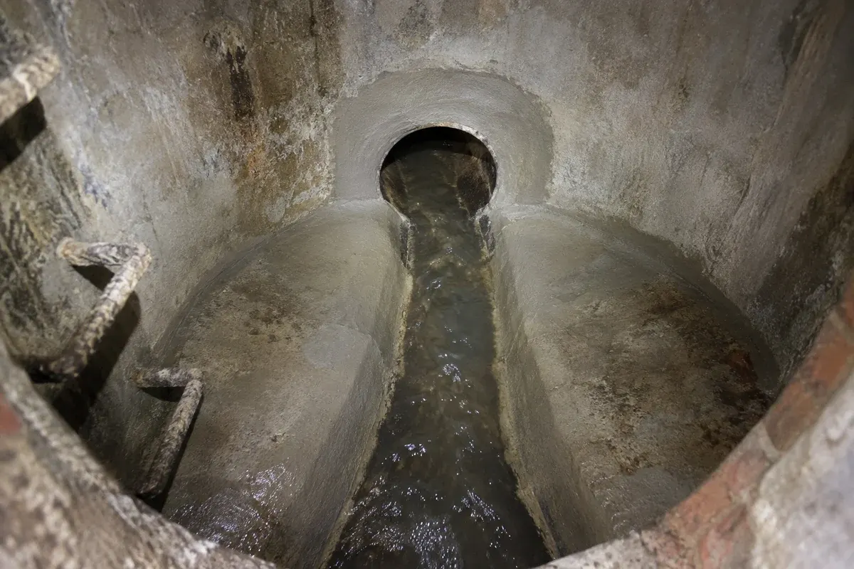 Condition illustration of repaired manhole joints, restored bench surfaces and finished pipe connections.